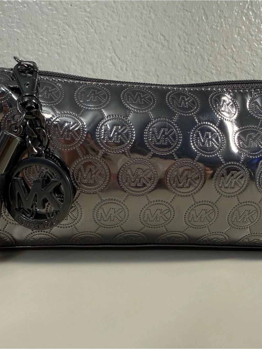 Michael Kors Shiny Silver MK Embossed Tassel Cosmetic Pouch